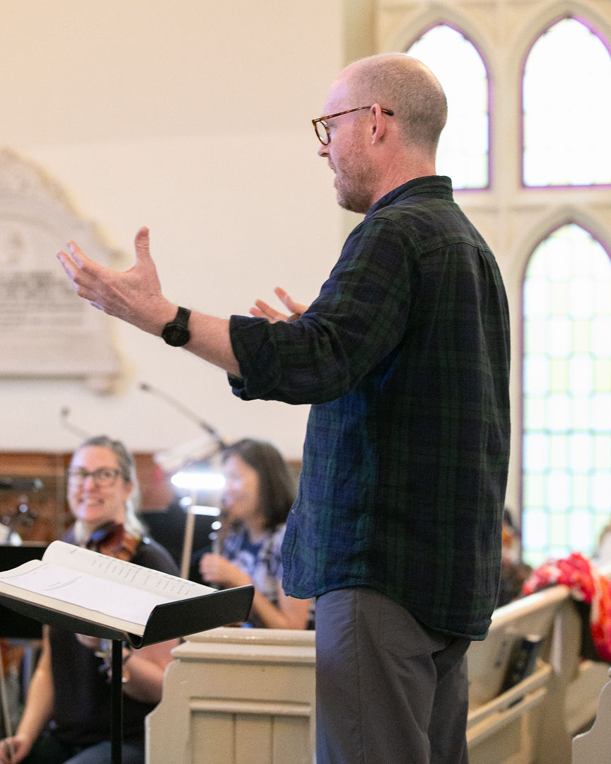 Music director Paul McCulloch conducts the orchestra.